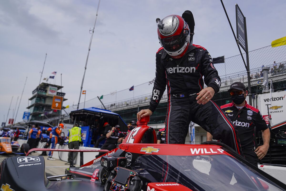 Will Power of Australia climbs into his car during practice for the Indianapolis 500 auto race at Indianapolis Motor Speedway in Indianapolis, Tuesday, May 18, 2021. (AP Photo/Michael Conroy)