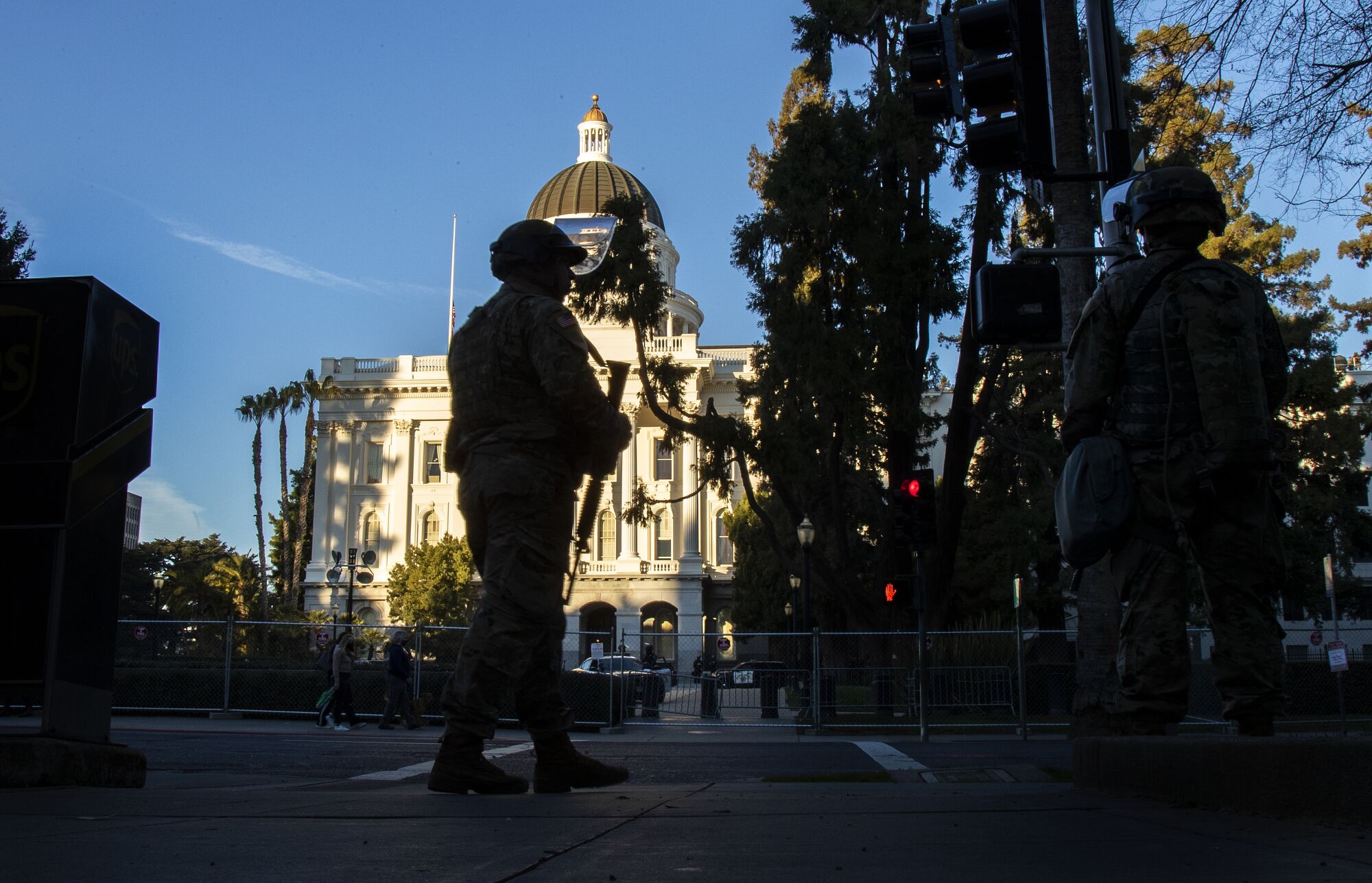 National Guard troops stand guard across from the state Capitol on Sunday in Sacramento.