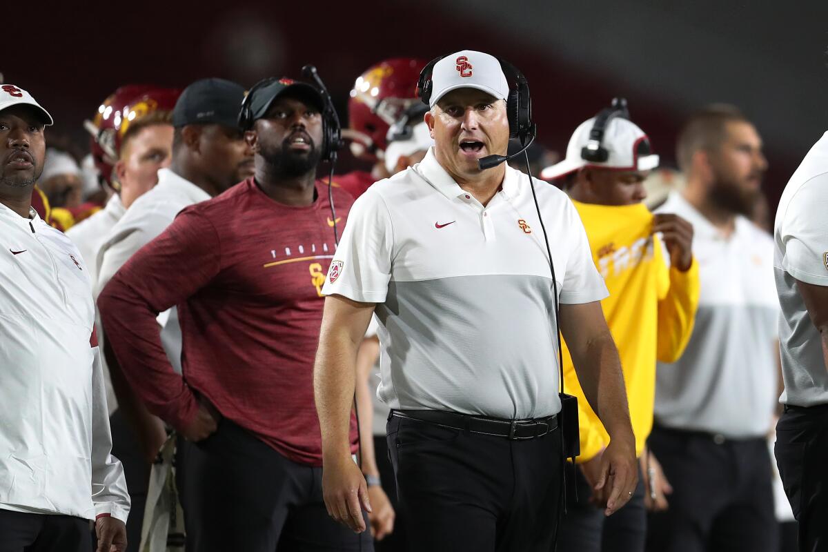 USC coach Clay Helton looks on from the sidelines during a win over Utah on Sept. 20.