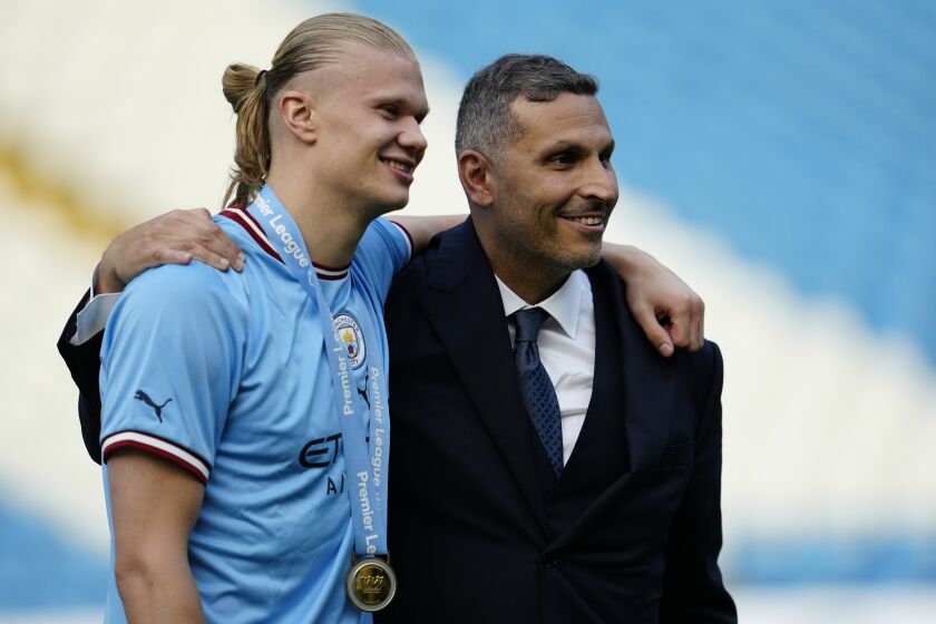 Chairman of Manchester City Khaldoon Al Mubarak, right, poses with Manchester City's Erling Haaland after the English Premier League soccer match between Manchester City and Chelsea at the Etihad Stadium in Manchester, England, Sunday, May 21, 2023. (AP Photo/Jon Super)