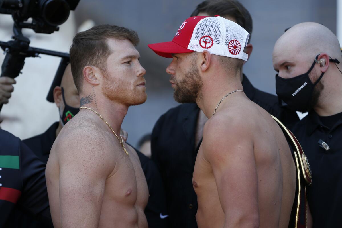 Boxers Canelo Alvarez, left, and Billy Joe Saunders, right, face off after the weigh-ins on Friday, May 7, 2021.