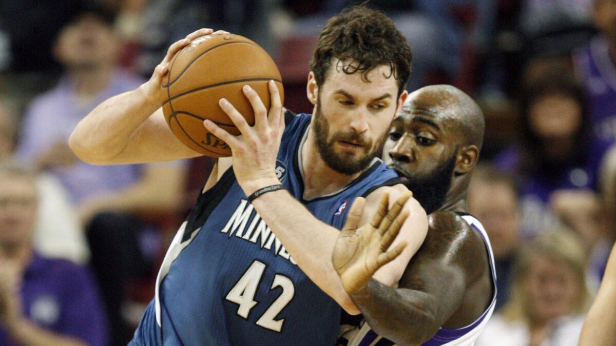 Minnesota Timberwolves forward Kevin Love, left, drives on Sacramento Kings forward Quincy Acy during a game in April. Would the Lakers be interested in trading their first-round draft pick for Love?