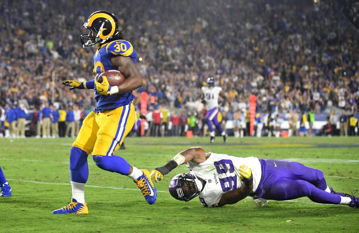 Rams running back Todd Gurley breaks free from Minnesota Vikings defensive end Danielle Hunter after a recption in the third quarter at the Coliseum.