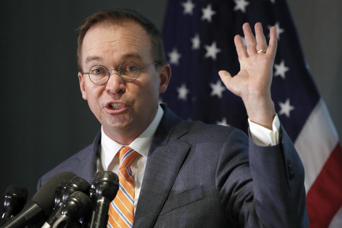 Mick Mulvaney speaks during a news conference after his first day as acting director of the Consumer Financial Protection Bureau in Washington on Nov. 27, 2017.