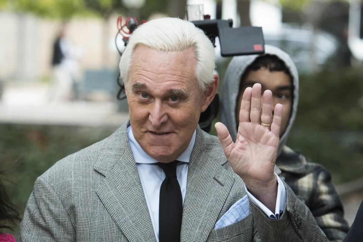 Roger Stone waves outside a federal court in Washington in November 2019. 