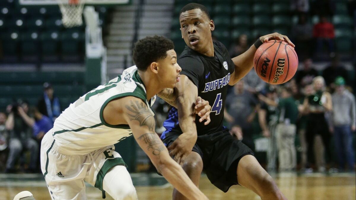 Buffalo guard Davonta Jordan tries to keep Eastern Michigan guard Kevin McAdoo from stealing the ball during the first half Friday.