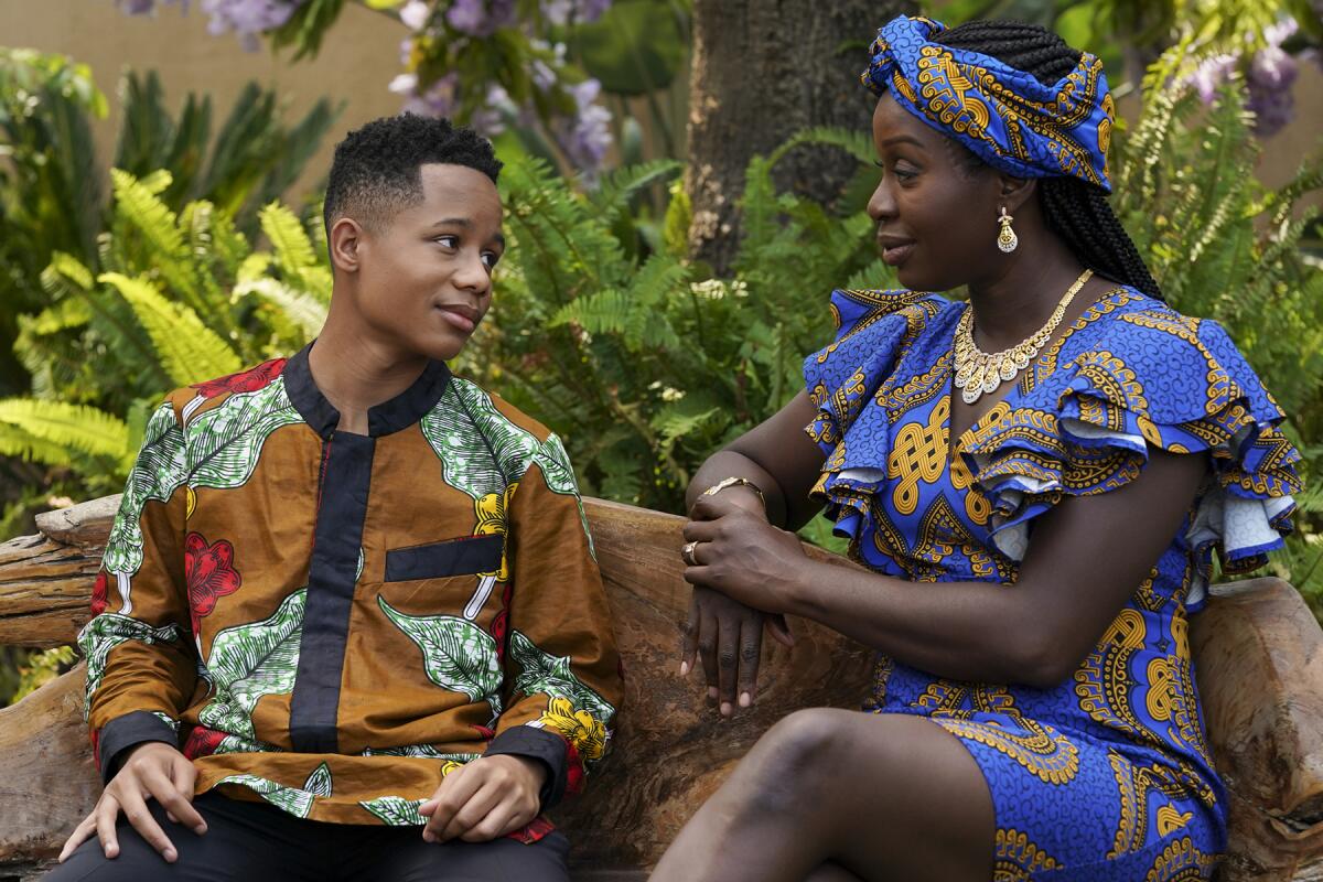 Travis Wolfe Jr. and Folake Olowofoyeku in "Bob Hearts Abishola" on CBS.