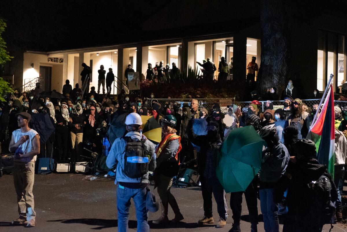 A crowd of protesters at Cal Poly Humboldt at night