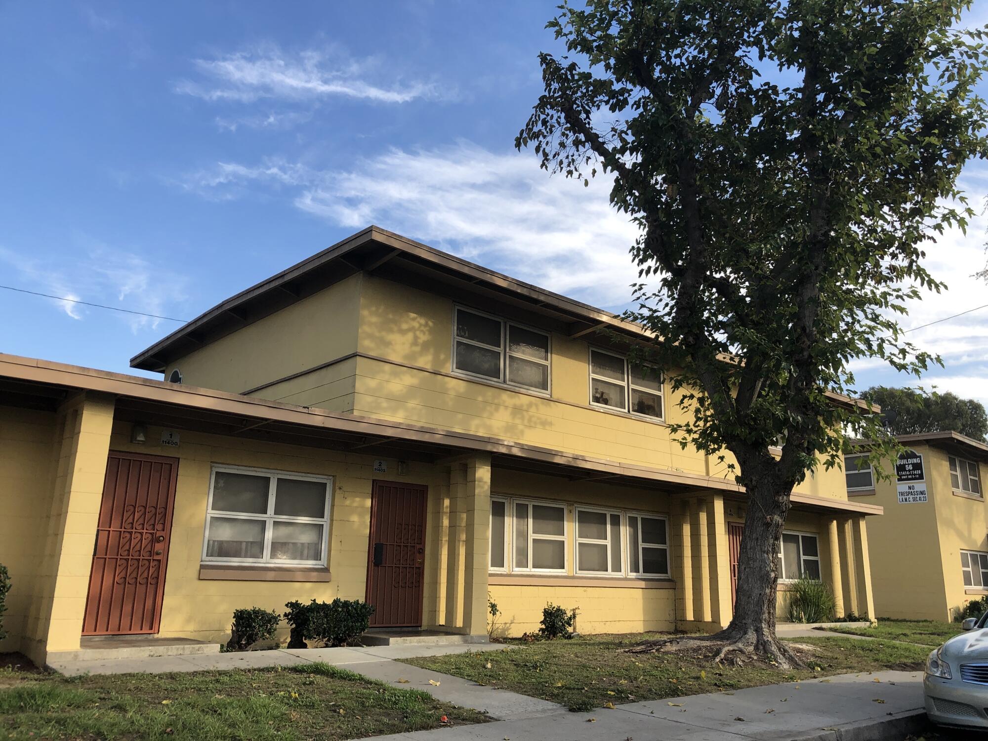 A Modern two-story apartment structure in yellow at Nickerson Gardens.