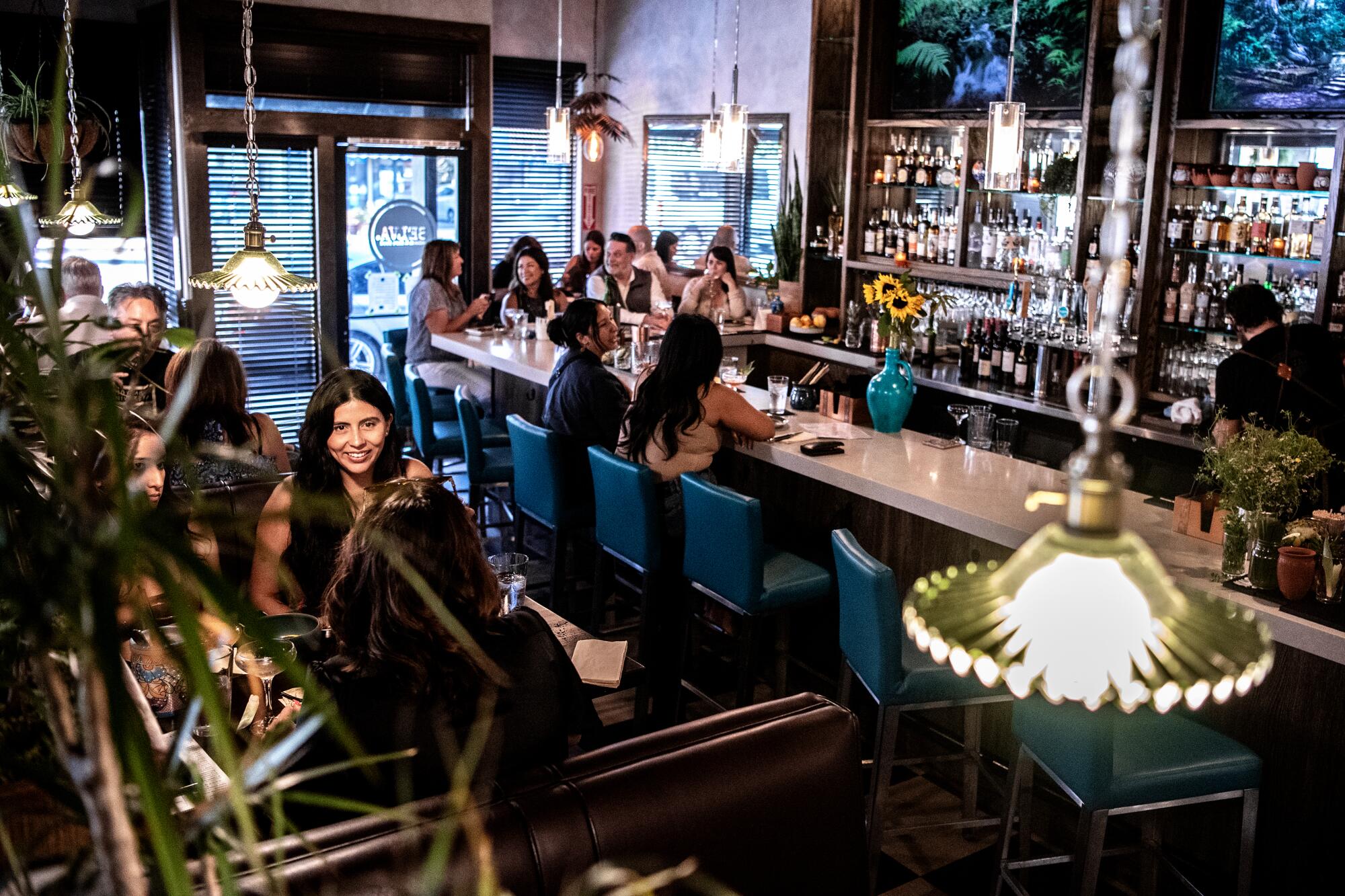 Customers dine and drink at a restaurant.