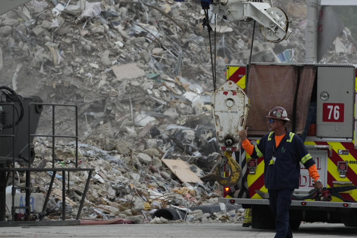 Crews work in the rubble of the demolished section of the Champlain Towers South building