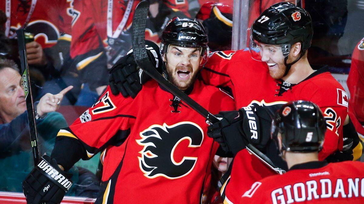 The Calgary Flames' Michael Frolik, left, celebrates his goal with teammate Dougie Hamilton during the first period against the New York Islanders on March 5.