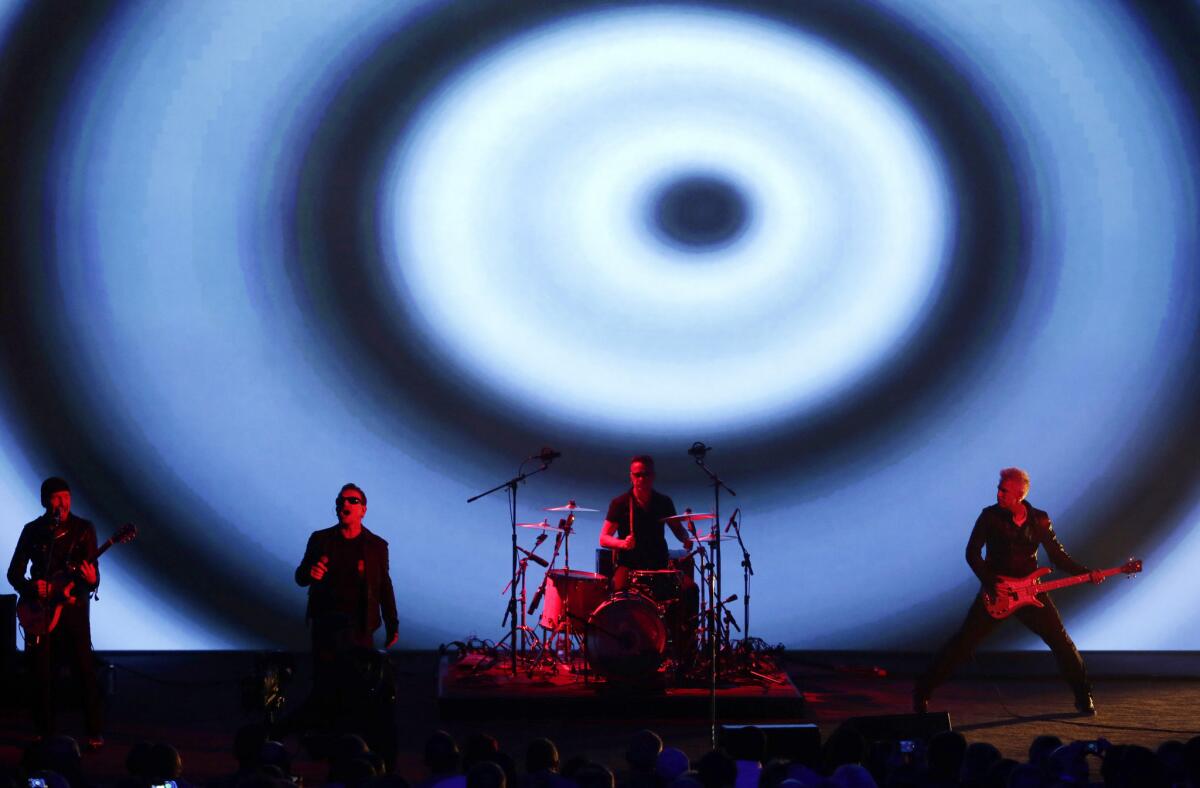 U2 perform during an announcement of new products by Apple in Cupertino, Calif.