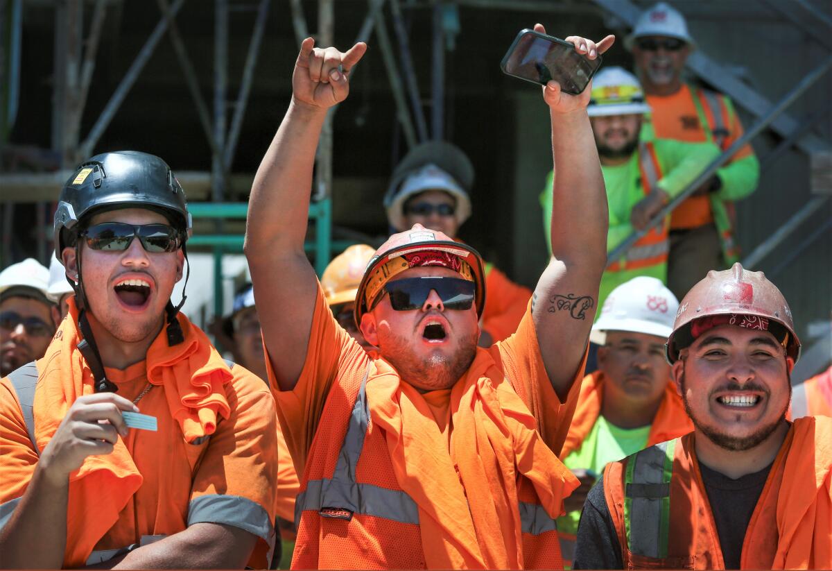 Workers cheer Thursday at a UCI Health ceremony to celebrate the progress of a new medical campus being built in Irvine.
