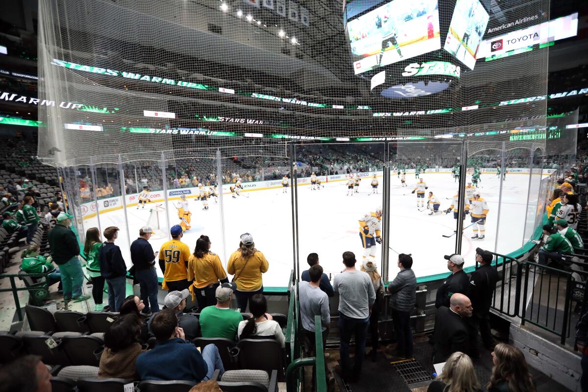 Fans watch warm ups before a game between the Nashville Predators and the Dallas Stars at American Airlines Center on March 7.
