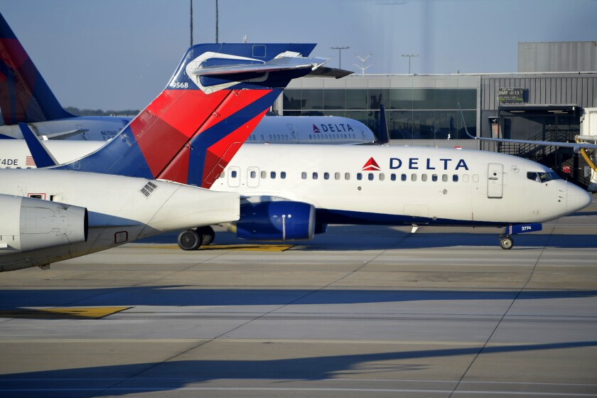 A Delta Airlines aircraft taxi's, Thursday, Dec. 2, 2021, at Hartsfield-Jackson Atlanta International Airport, in Atlanta. Delta Air Lines lost $940 million in the first quarter, Wednesday, April 13, 2022, yet bookings surged in recent weeks, setting up a breakout summer as Americans try to put the pandemic behind them. While Delta's revenue is recovering, the Atlanta airline faces stiff headwinds from higher spending on fuel and labor. (AP Photo/Mike Stewart)