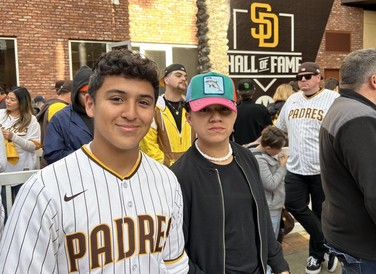 Damian Cortez (left) and Miguel Espinoza wait in line at the Padres Team Store in order to get a new jersey for Espinoza.