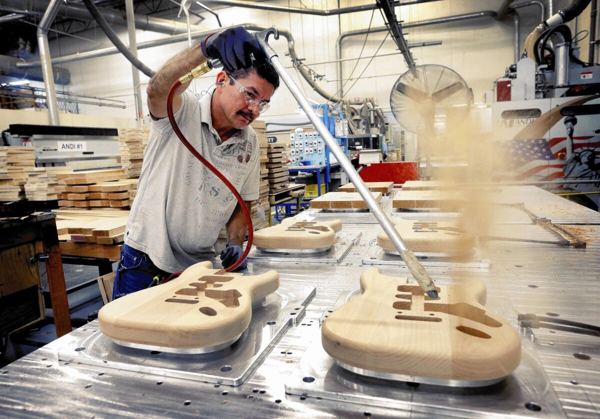 Factory employment has fallen nearly 34% in the last 15 years. Above, Manuel Espinoza works on guitar bodies last year at the Fender plant in Corona.
