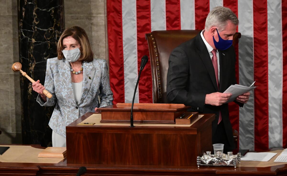 Speaker of the House Nancy Pelosi holds the gavel after House Minority Leader Kevin McCarthy handed it to her.