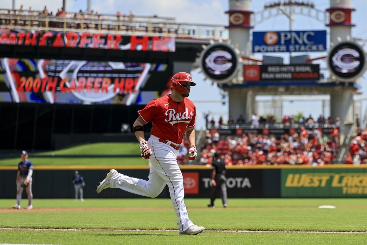 Cincinnati Reds' Mike Moustakas runs the bases after hitting a two-run home run during the third inning of a baseball game against the Tampa Bay Rays in Cincinnati, Sunday, July 10, 2022. (AP Photo/Aaron Doster)