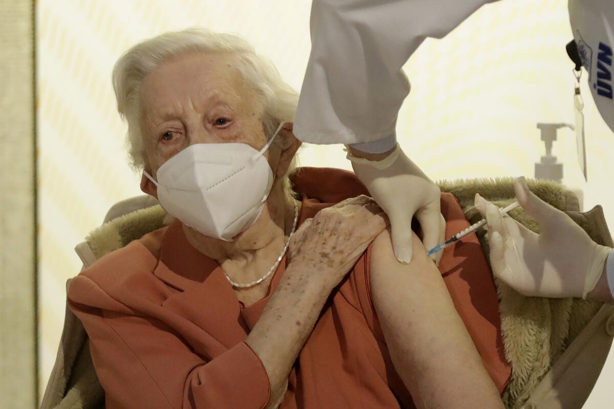 World War II veteran Emilie Repikova receives a COVID-19 vaccine at a military hospital.