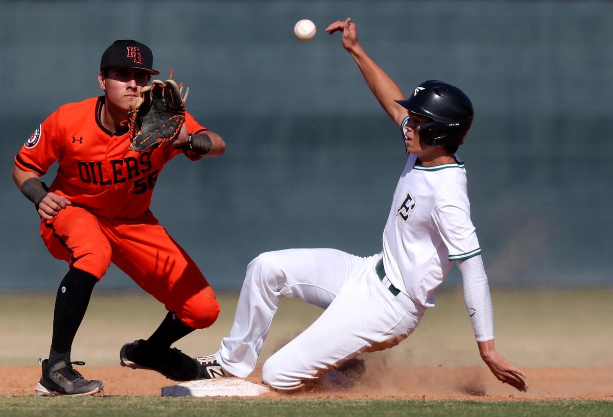 Edison's Josh Nowlin, right, beats the throw to second against Huntington Beach's Brian Trujillo during the third inning.