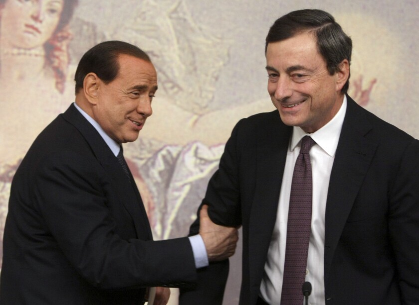 FILE - Former and present Italian Premiers Silvio Berlusconi, left, and Mario Draghi, right, are seen during a press conference at Chigi Palace,in Rome, on Oct. 8, 2008. Italy’s lower chamber of parliament on Tuesday set Jan. 24 as the start date to begin voting for a new Italian president, officially kicking off a campaign that is expected to see Premier Mario Draghi and ex-Premier Silvio Berlusconi vie for the prestigious job. The victor, who is chosen by around 1,000 “big electors" among lawmakers and regional representatives, will replace President Sergio Mattarella, whose seven-year term ends Feb. 3. The voting is expected to last several rounds over several days. (AP Photo/Sandro Pace)