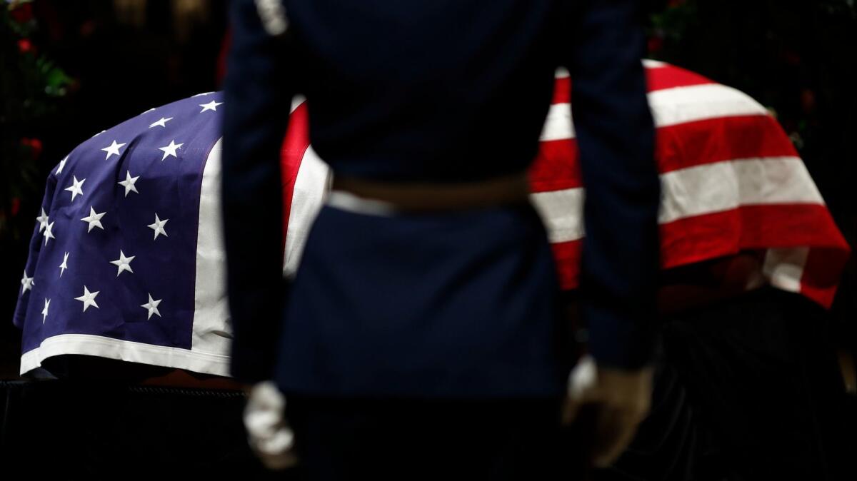 A flag-draped casket containing the body of former U.S. President George H.W. Bush lies in state Tuesday at the Rotunda of the Capitol in Washington, D.C.,