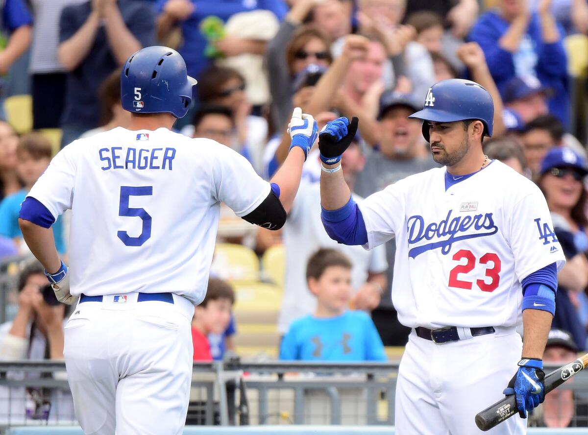 Dodgers' Corey Seager, left, celebrates his solo homerun with Adrian Gonzalez to tie the score 1-1 with the St. Louis Cardinals during the third inning.