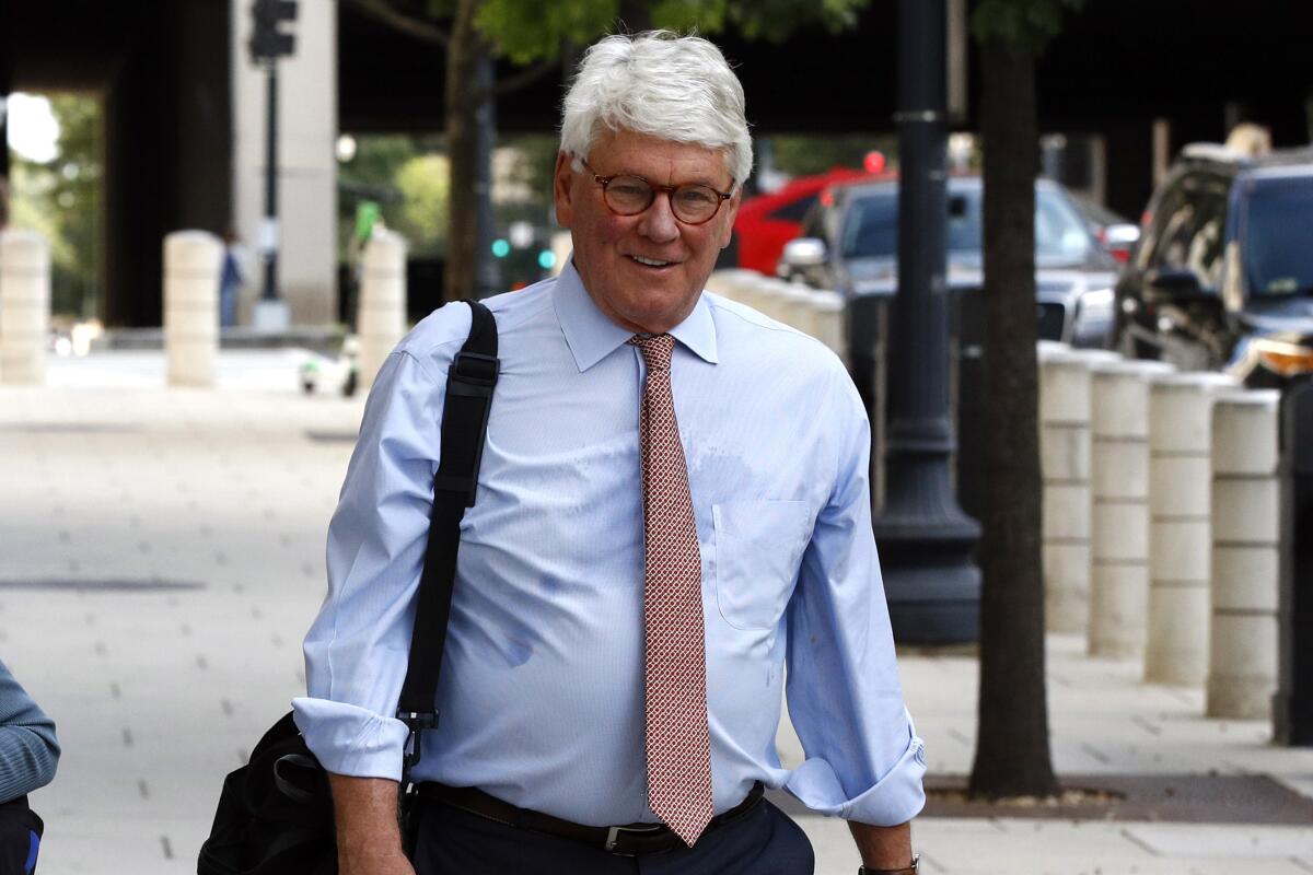 FILE - In this Aug. 22, 2019, file photo, Greg Craig, right, former White House counsel to former President Barack Obama, walks into a federal courthouse for his trial, in Washington. Craig was found not guilty of lying to the Justice Department about work he did for the government of Ukraine in a case that arose from the special counsel’s Russia investigation and that centered on the lucrative world of foreign lobbying. (AP Photo/Patrick Semansky, File)
