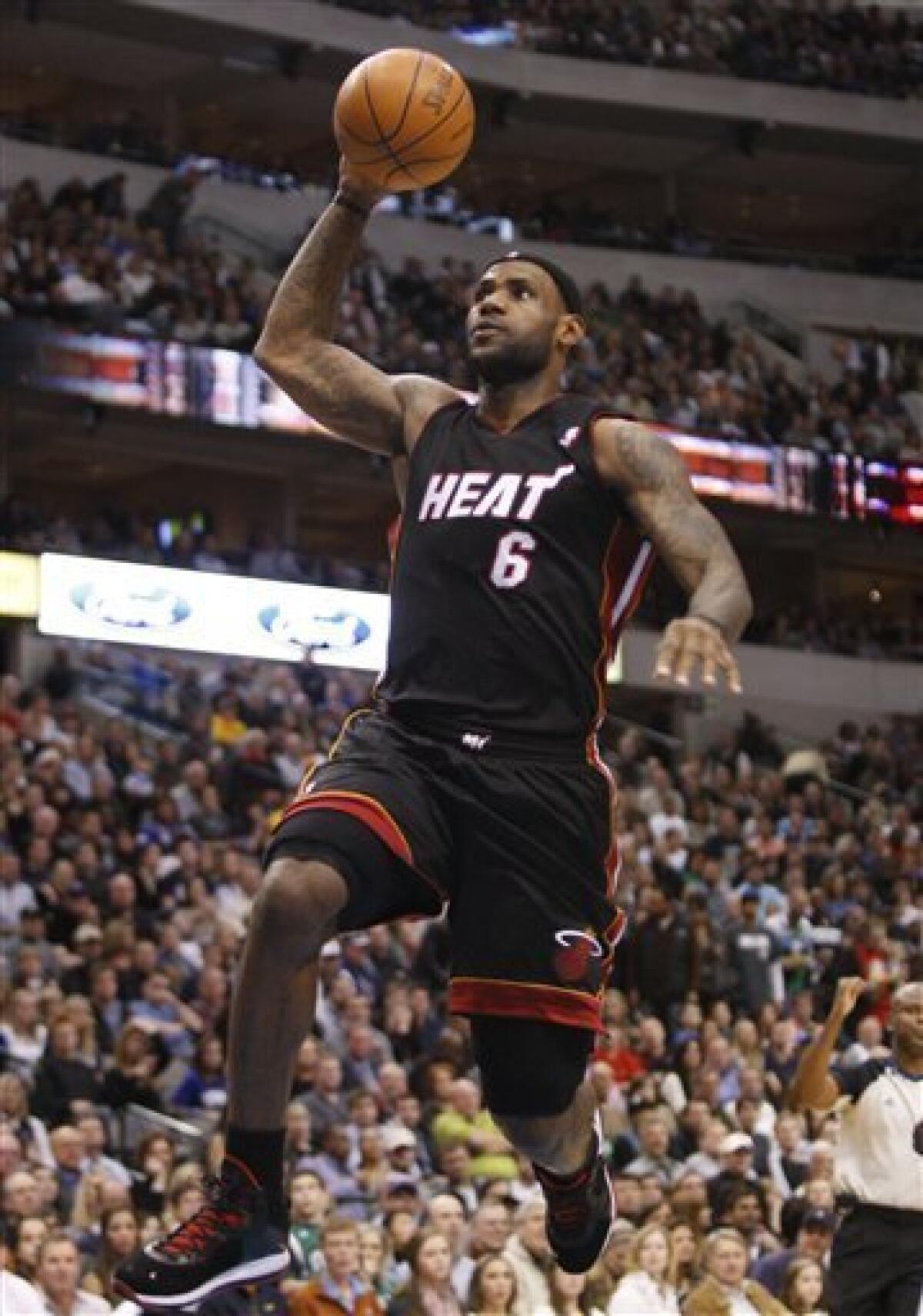 The Miami Heat's Lebron James (6) is fouled by the Dallas
