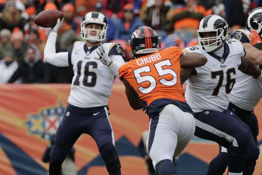 DENVER, CO - OCTOBER 14, 2018: Los Angeles Rams offensive guard Rodger Saffold (76) keeps Denver Broncos linebacker Bradley Chubb (55) away from Los Angeles Rams quarterback Jared Goff (16) in the first half at Broncos Stadium at Mile High on October 14, 2018 in Denver, Colorado.(Gina Ferazzi/Los AngelesTimes)