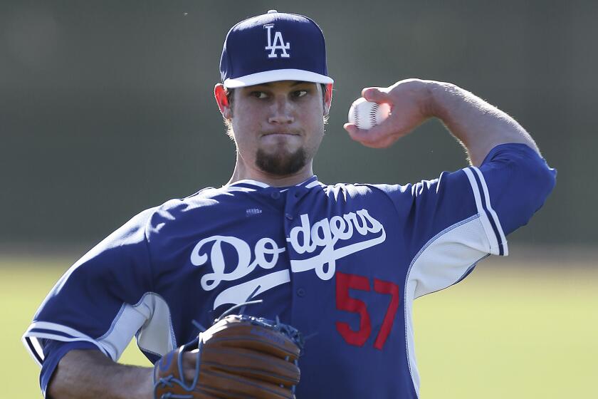 Pitcher Scott Elbert throws during a Dodgers spring training practice session on Feb. 10. Elbert has undergone three elbow surgeries in the last two years.