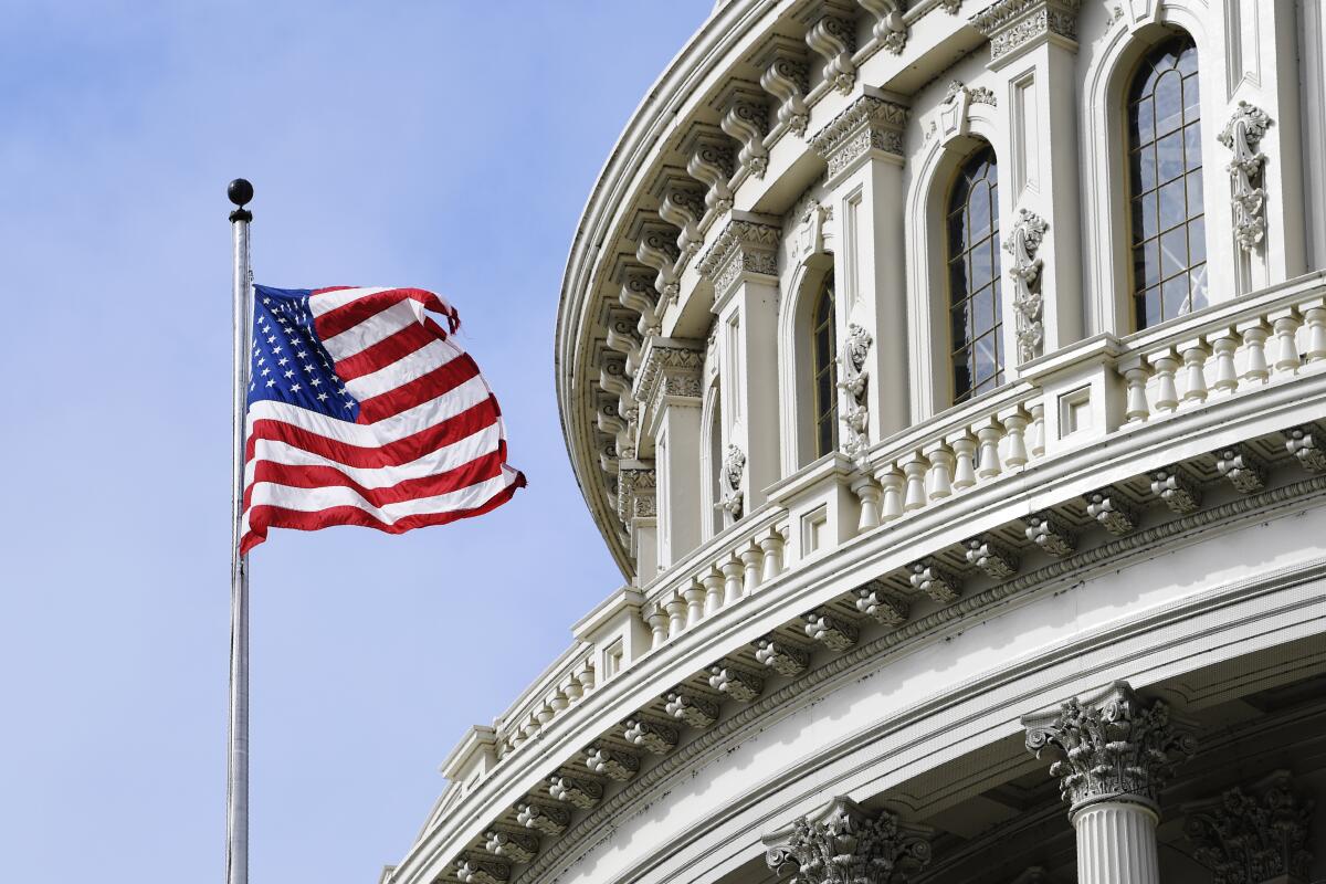 The American flag flies on Capitol Hill in Washington.
