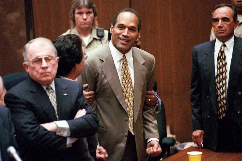 O.J. Simpson, center, after being found not guilty of murder in the deaths of Nicole Brown Simpson and her friend Ronald Goldman. The court case is part of the documentary "O.J.: Made in America