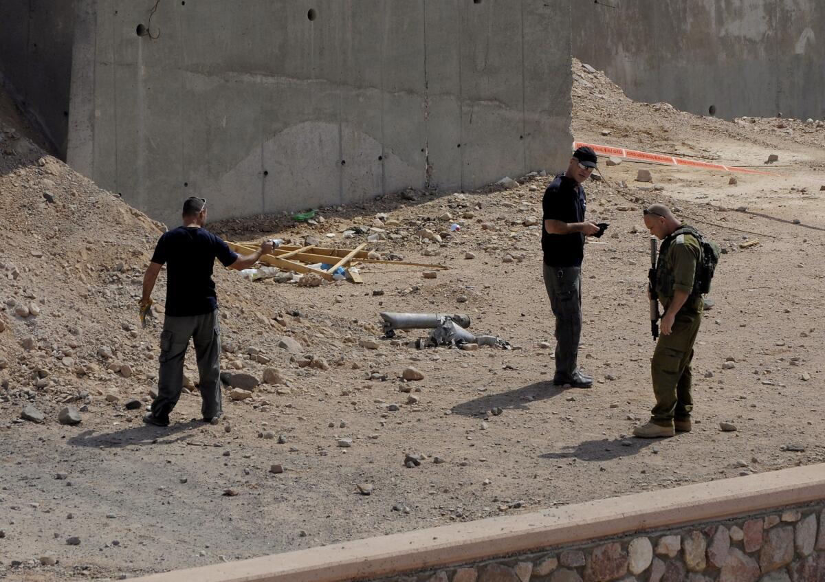 Israeli security officers investigate the scene of a rocket attack in Eilat.