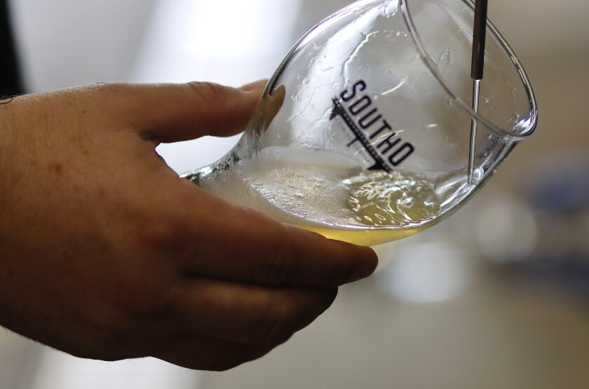 Head Brewer Maurey Fletcher pours a pint at South O Brewing in Oceanside.