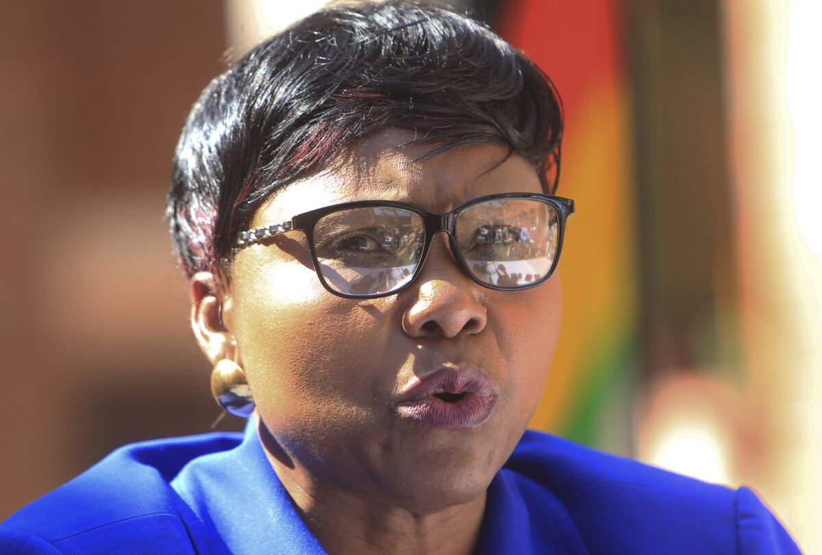 FILE - In this July 31, 2015 Oppah Muchinguri, then Zimbabwean Minister of Environment, Water and Climate, addresses a press conference in Harare, Now Defence Minister Muchinguri has described the coronavirus as God's way of punishing the United States and other western countries for imposing sanctions on Zimbabwe, prompting the president to issue a statement Monday, March 16, 2020 restating his government's commitment to fighting COVID-19. (AP Photo/Tsvangirayi Mukwazhi, File)
