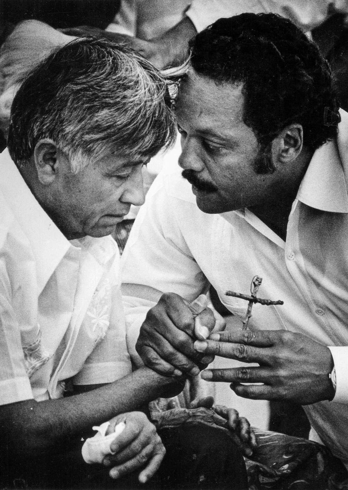 Aug. 21, 1988: Chavez passes a wooden cross to Jesse Jackson during a Mass to end the union leader's 36-day fast protesting use of pesticides on table grapes. This image was published in the Aug. 22, 1988, Los Angeles Times.