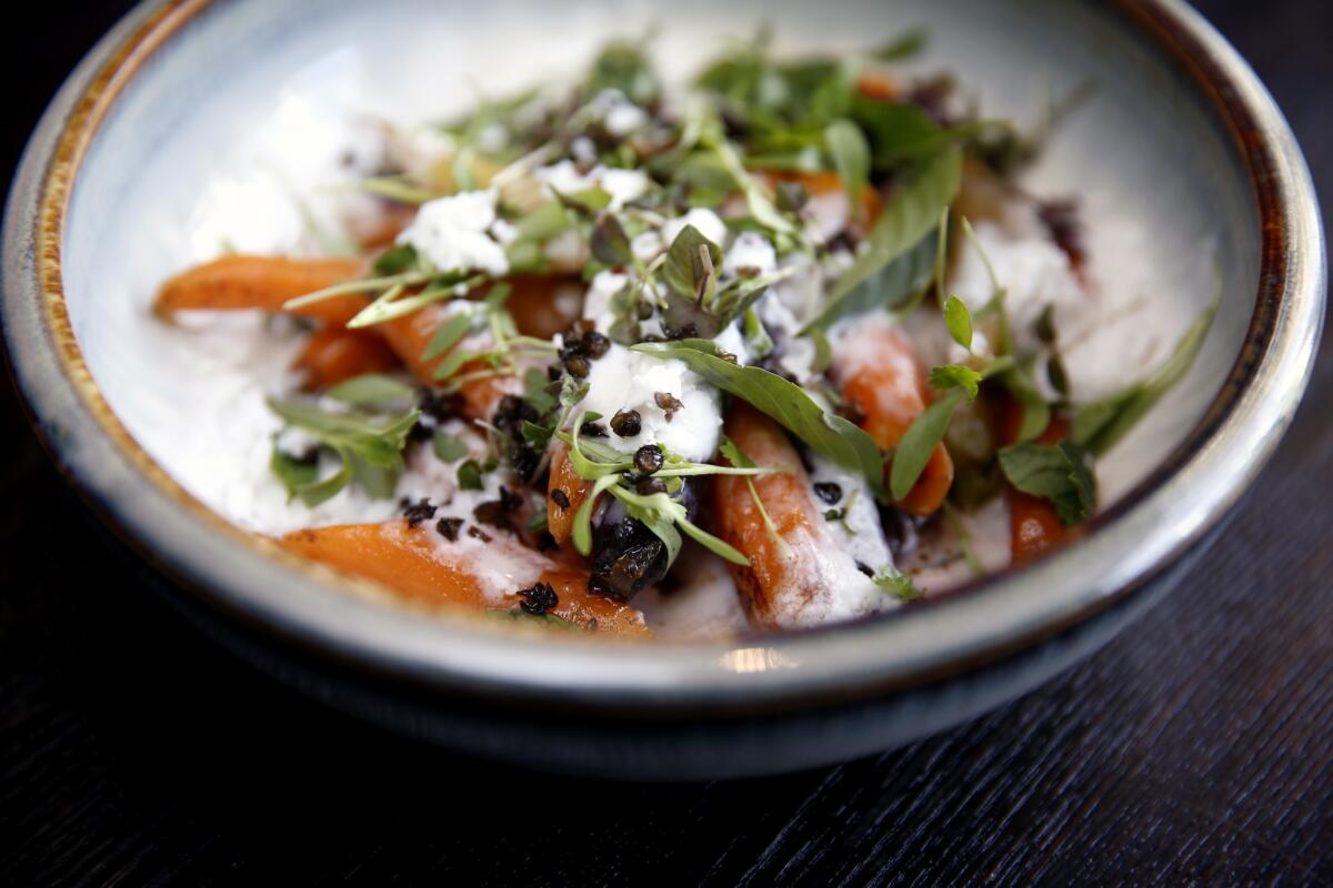 Roasted carrots with coconut, crispy lentils, Thai herbs and tamarind sriracha at Erven.