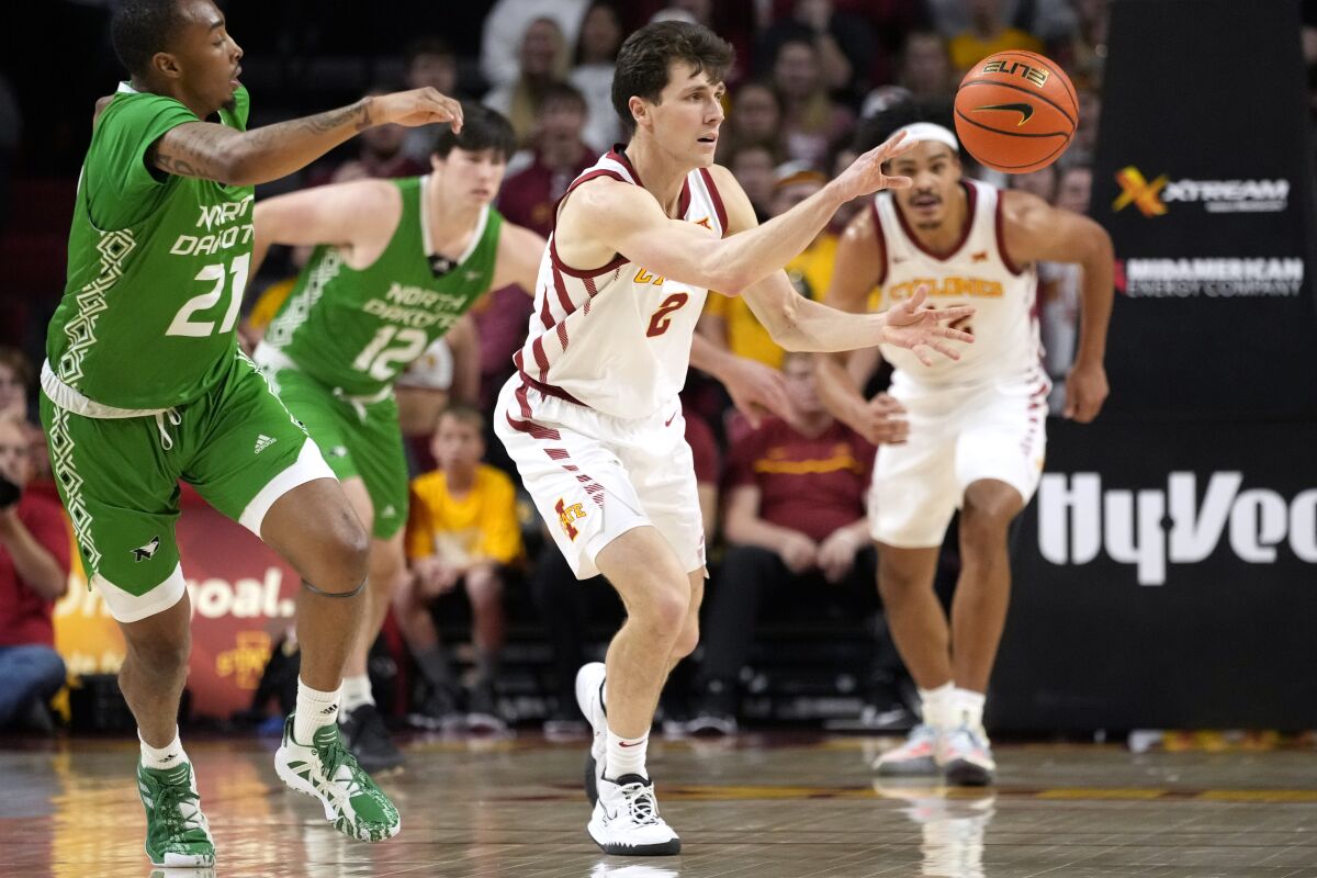 Iowa State guard Caleb Grill (2) steals the ball from North Dakota forward A'Jahni Levias (21) during the first half of an NCAA college basketball game, Wednesday, Nov. 30, 2022, in Ames, Iowa. (AP Photo/Charlie Neibergall)