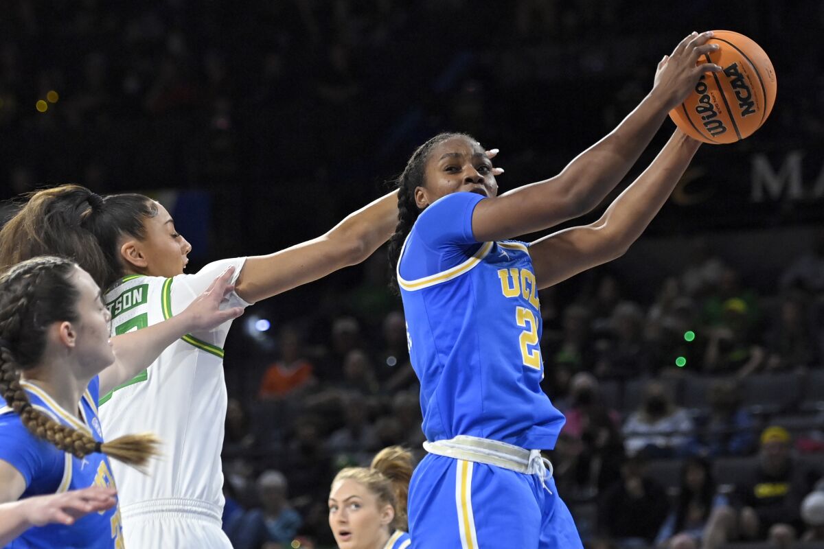 UCLA guard Charisma Osborne (20) rebounds the ball against Oregon on March 3