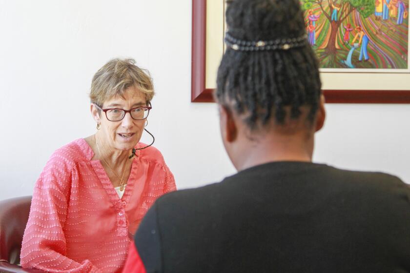 Aliah (right), who is from Cameroon and refused to be identified, talks to her attorney Nancy Aeling at the Casa Cornelia law offices in Bankers Hill on October 11, 2019 in San Diego, California. Aliah won her asylum case.