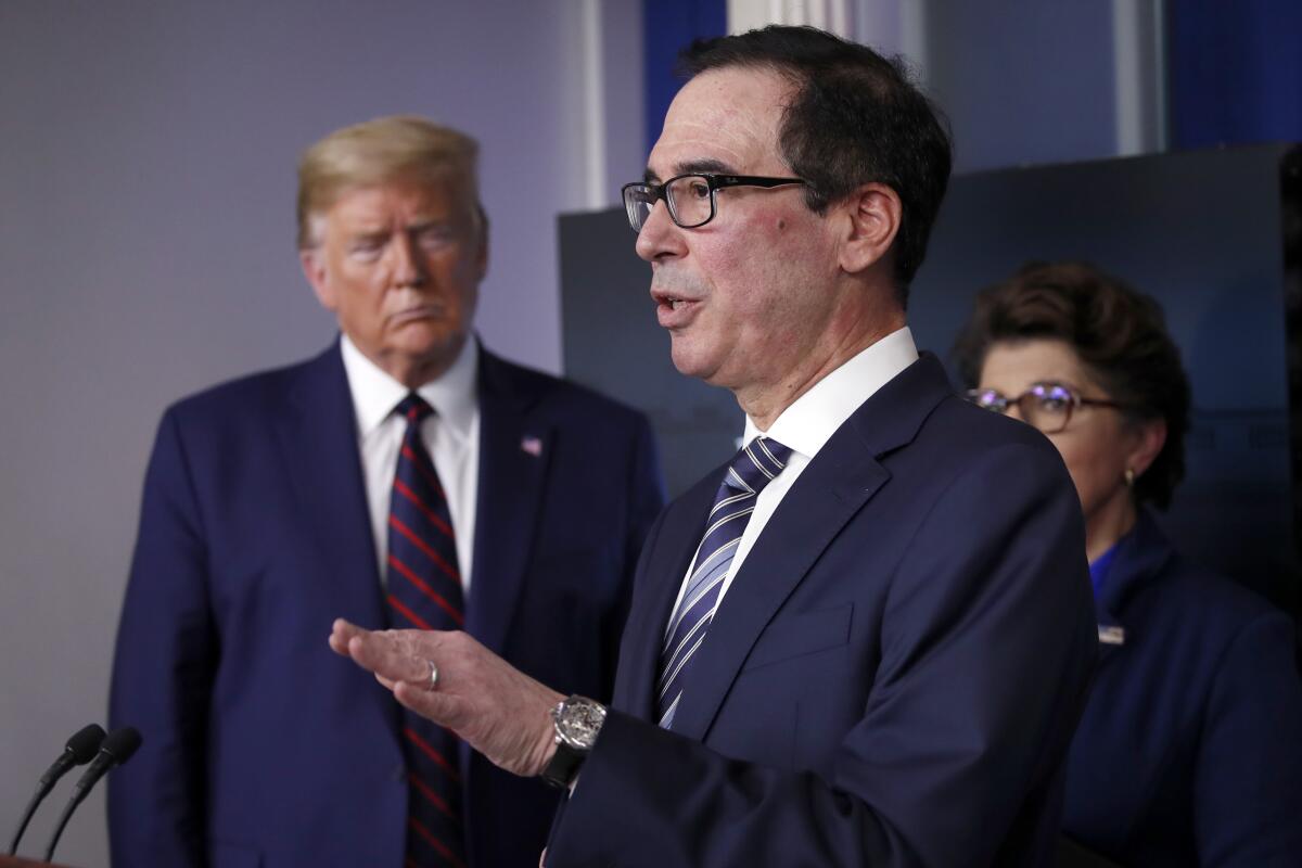 President Trump and Jovita Carranza, administrator of the Small Business Administration, listen as Treasury Secretary Steven T. Mnuchin speaks about the coronavirus.