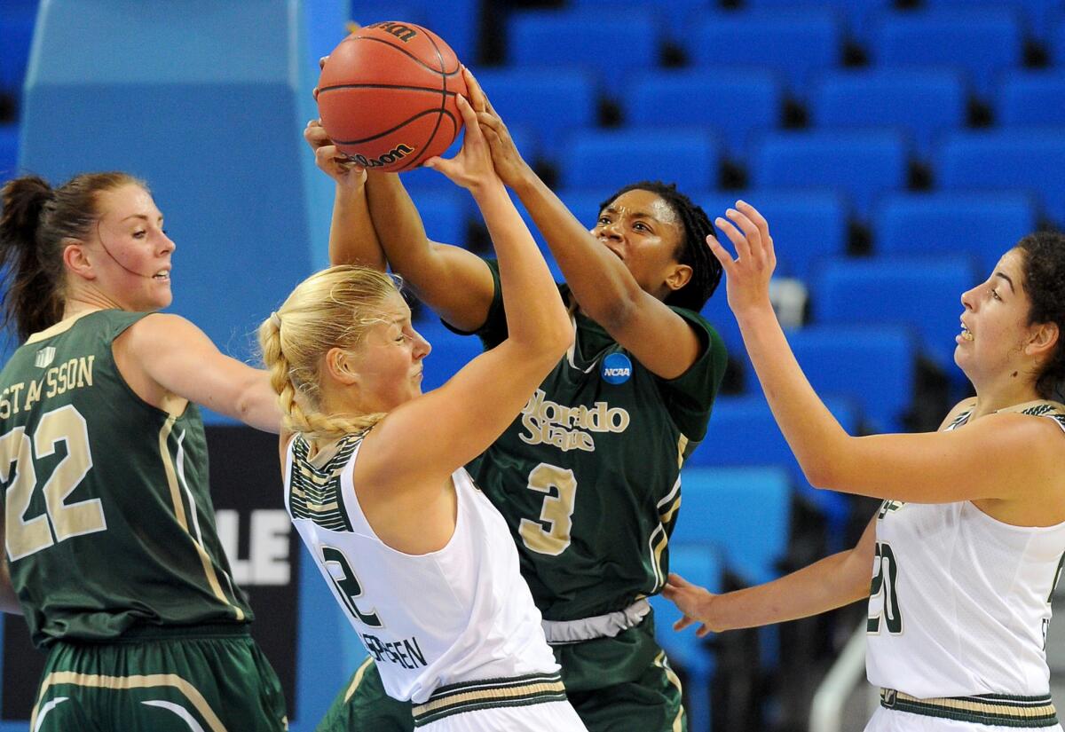 Colorado State's Keyora Wharry (3) and South Florida's Maria Jespersen, center, battle for a rebound during an NCAA tournament game on March 19.
