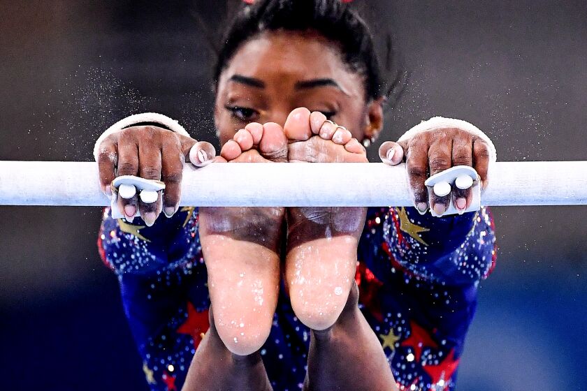 -TOKYO,JAPAN July 24, 2021: USA's Simone Biles competes on the uneven bars in the women's team qualifying at the 2020 Tokyo Olympics. (Wally Skalij /Los Angeles Times)