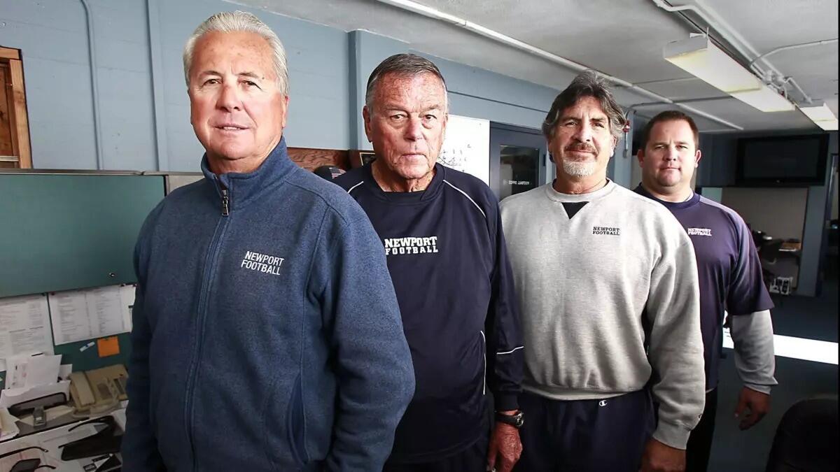 Matt Burns, far right, was a longtime assistant coach for Newport Harbor football under Jeff Brinkley, left. 