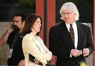 Michael Jackson's attorney, Thomas Mesereau Jr., and Deborah Opri, the attorney for Jackson's father, wait for Jackson to arrive at Santa Barbara County Superior Court in Santa Maria. Jackson, on trial for child molestation, was late getting to court after going to a hospital with complaints of back pain. The judge issued a bench warrant giving him an hour to get to court, which Jackson failed to meet.