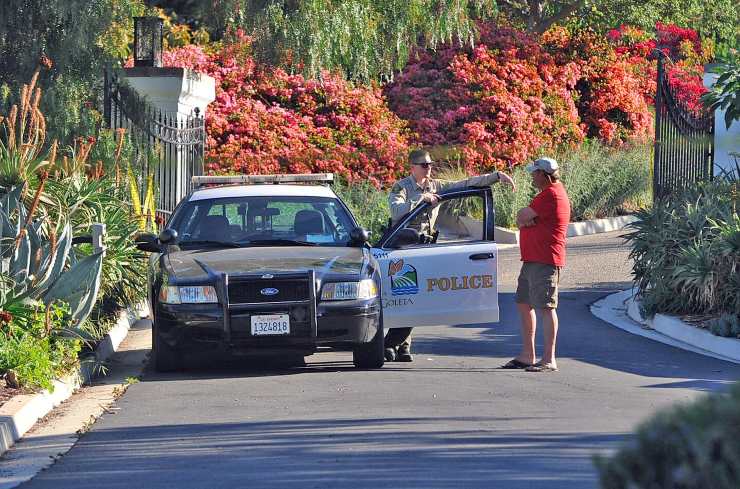 A Goleta police officer stands guard near the doctor's home on Greenhill Way.