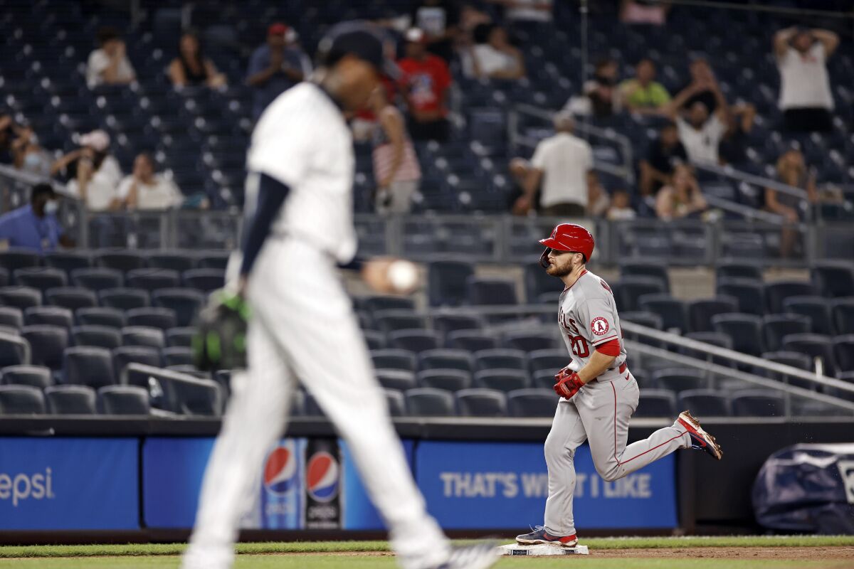 Jared Walsh circles the bases after hitting a grand slam in the ninth inning against the Yankees.